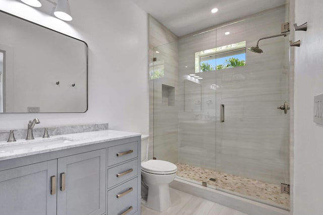 12952 Drayton Rd, North Palm Beach, FL 33408 - full bathroom featuring toilet, a shower stall, vanity, and recessed lighting