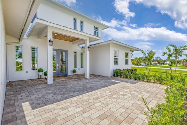 12952 Drayton Rd, North Palm Beach, FL 33408 - rear view of property with a patio area, stucco siding, and french doors