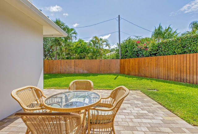 12952 Drayton Rd, North Palm Beach, FL 33408 - view of patio with outdoor dining space and a fenced backyard