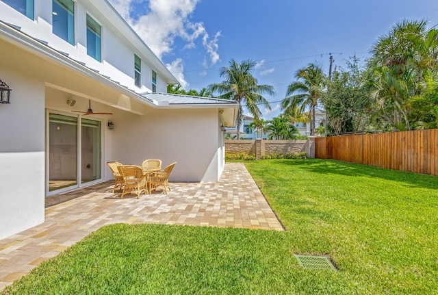 12952 Drayton Rd, North Palm Beach, FL 33408 - view of yard featuring a patio, visible vents, and a fenced backyard