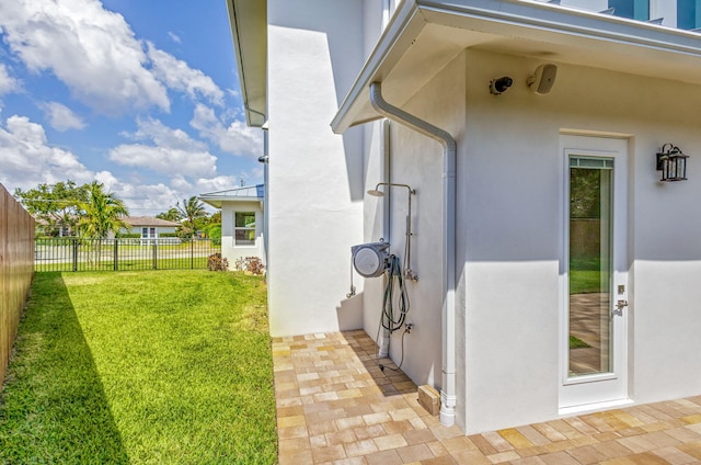 12952 Drayton Rd, North Palm Beach, FL 33408 - exterior space with fence, a yard, stucco siding, metal roof, and a standing seam roof