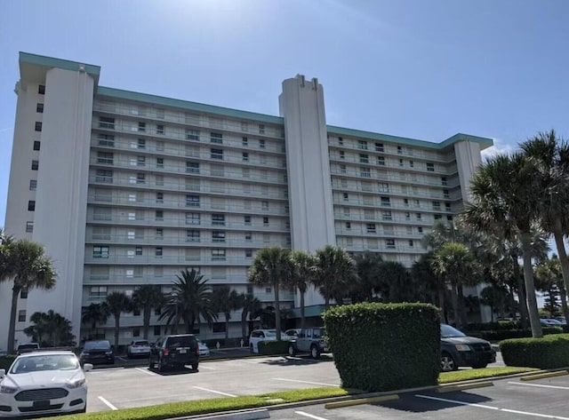 view of building exterior with uncovered parking