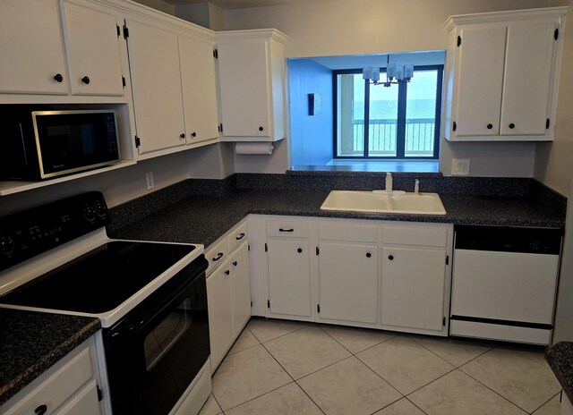 9940 S Ocean Dr Unit 1005, Jensen Beach, FL 34957 - kitchen with range with electric stovetop, white dishwasher, a chandelier, white cabinets, and light tile patterned floors