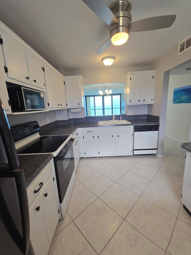 kitchen with ceiling fan with notable chandelier, a sink, electric range oven, visible vents, and dishwasher