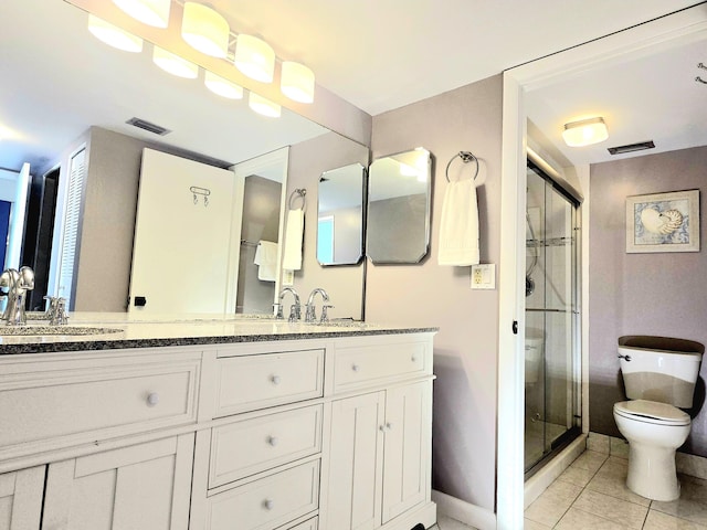 9940 S Ocean Dr Unit 1005, Jensen Beach, FL 34957 - bathroom with toilet, double vanity, a shower stall, and tile patterned floors