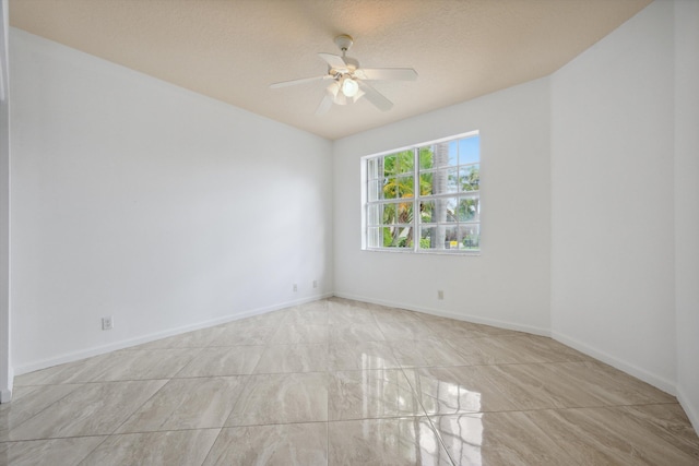 4065 Manchester Lake Dr, Lake Worth, FL 33449 - empty room with a ceiling fan and baseboards