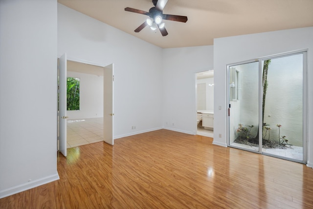 4065 Manchester Lake Dr, Lake Worth, FL 33449 - empty room with vaulted ceiling, ceiling fan, light wood-style flooring, healthy amount of natural light, and baseboards