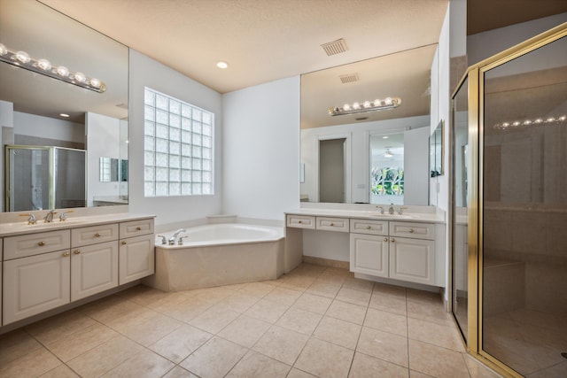 4065 Manchester Lake Dr, Lake Worth, FL 33449 - full bathroom featuring a shower stall, tile patterned floors, two vanities, and a garden tub