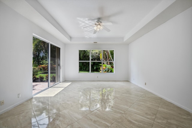 4065 Manchester Lake Dr, Lake Worth, FL 33449 - unfurnished room with ceiling fan, a tray ceiling, and baseboards