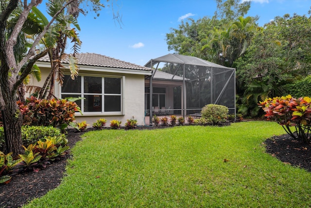 4065 Manchester Lake Dr, Lake Worth, FL 33449 - back of property featuring stucco siding, a tiled roof, a yard, and glass enclosure