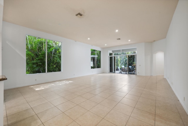 4065 Manchester Lake Dr, Lake Worth, FL 33449 - spare room featuring light tile patterned flooring, recessed lighting, baseboards, and arched walkways