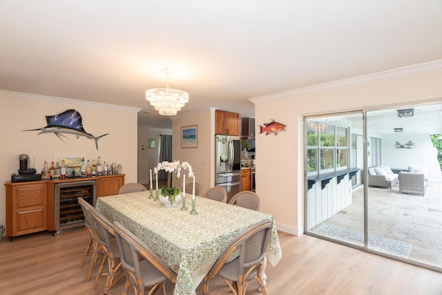 dining area with light wood finished floors, beverage cooler, crown molding, and a notable chandelier