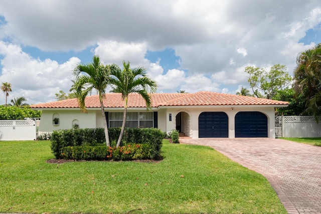 view of front facade featuring a garage, stucco siding, fence, a front lawn, and decorative driveway