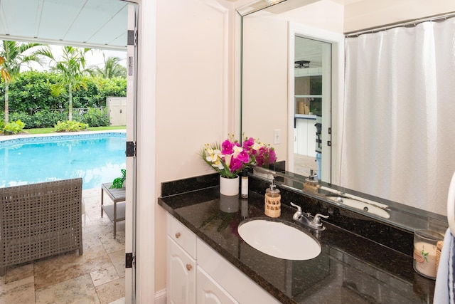 bathroom featuring vanity and stone finish flooring
