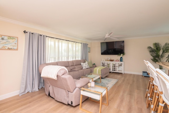 living area featuring light wood finished floors, baseboards, and ornamental molding