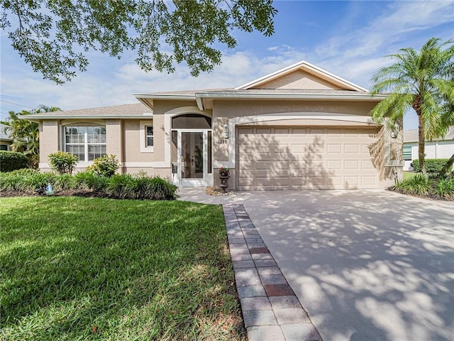 1295 Sebastian Lakes Dr, Sebastian, FL 32958 - view of front of property featuring an attached garage, concrete driveway, stucco siding, and a front lawn