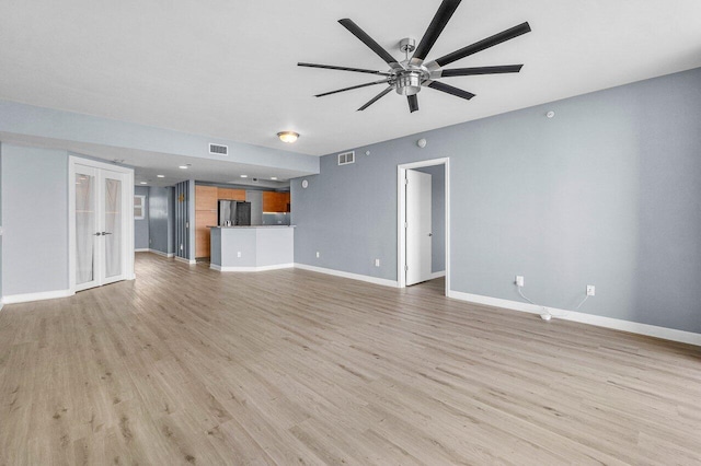 2640 Lake Shore Dr Unit 614, Riviera Beach, FL 33404 - unfurnished living room featuring a ceiling fan, baseboards, light wood finished floors, and french doors