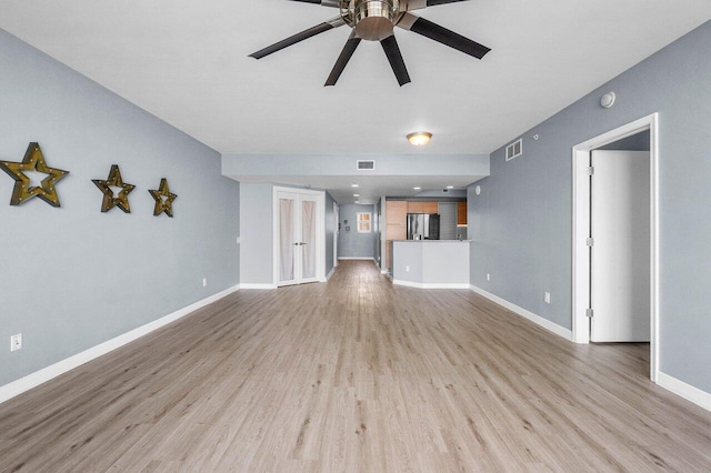 2640 Lake Shore Dr Unit 614, Riviera Beach, FL 33404 - unfurnished living room with ceiling fan, light wood-style floors, and baseboards