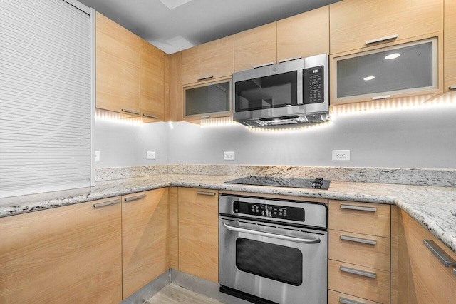 2640 Lake Shore Dr Unit 614, Riviera Beach, FL 33404 - kitchen with appliances with stainless steel finishes, light brown cabinetry, light stone countertops, and glass insert cabinets