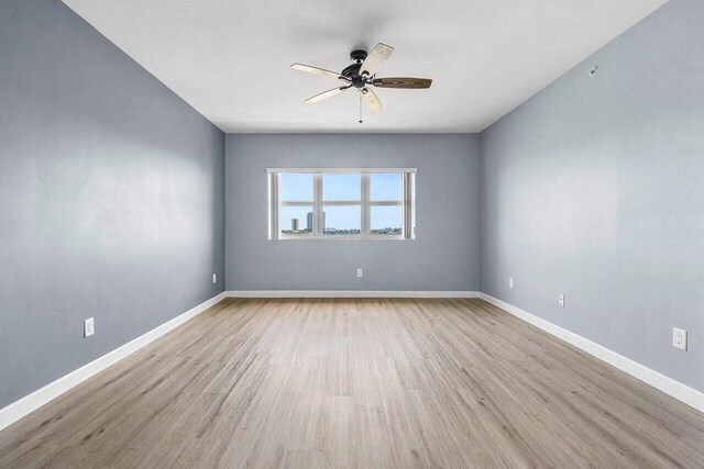2640 Lake Shore Dr Unit 614, Riviera Beach, FL 33404 - empty room featuring a ceiling fan, wood finished floors, and baseboards