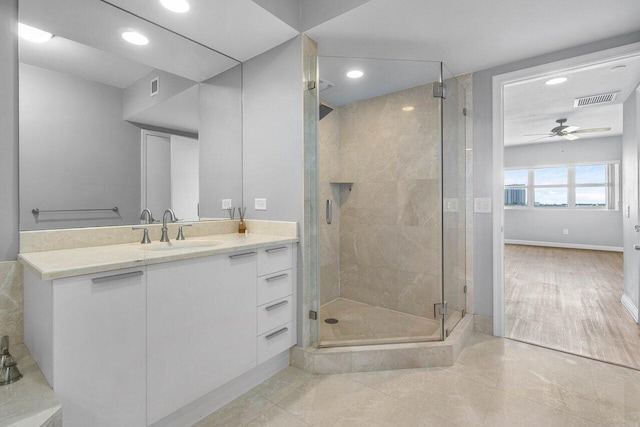 2640 Lake Shore Dr Unit 614, Riviera Beach, FL 33404 - bathroom featuring ceiling fan, a stall shower, recessed lighting, vanity, and baseboards