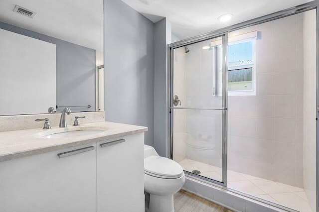 2640 Lake Shore Dr Unit 614, Riviera Beach, FL 33404 - bathroom with toilet, a shower stall, and vanity