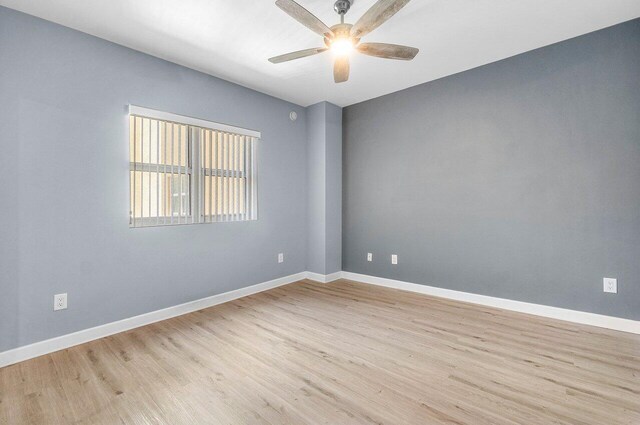 2640 Lake Shore Dr Unit 614, Riviera Beach, FL 33404 - spare room with light wood finished floors, ceiling fan, and baseboards