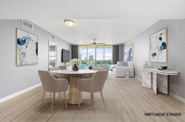 2640 Lake Shore Dr Unit 614, Riviera Beach, FL 33404 - dining area with light wood finished floors, baseboards, ceiling fan, and expansive windows