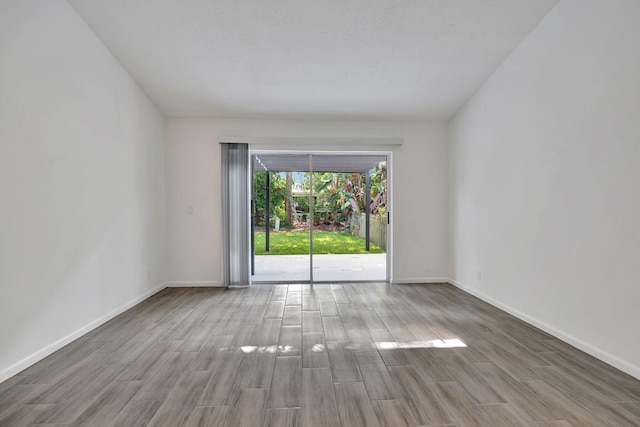 empty room with wood finished floors and baseboards