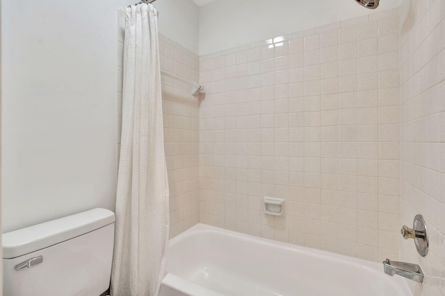 bathroom with shower / tub combo with curtain and toilet