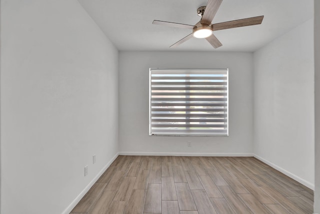 spare room featuring ceiling fan, wood finished floors, and baseboards