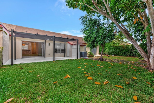 rear view of house with a patio, a pergola, central AC, and stucco siding
