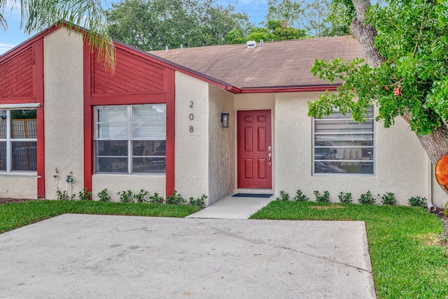 multi unit property with stucco siding and roof with shingles