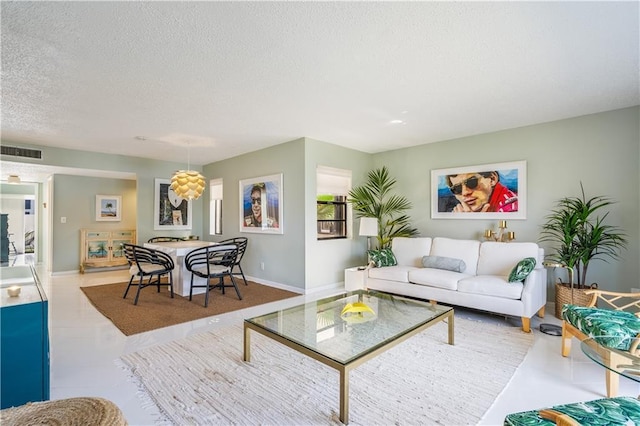 3215 S Lakeview Cir Unit 12104, Hutchinson Island, FL 34949 - living room featuring a textured ceiling and baseboards