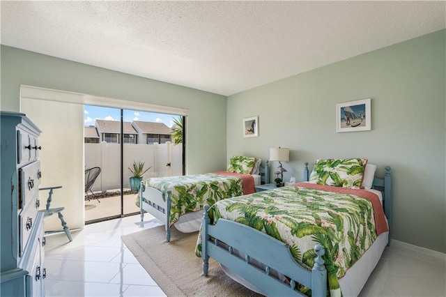 3215 S Lakeview Cir Unit 12104, Hutchinson Island, FL 34949 - bedroom featuring access to outside, a textured ceiling, and light tile patterned floors