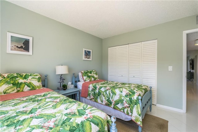 3215 S Lakeview Cir Unit 12104, Hutchinson Island, FL 34949 - bedroom with a closet, a textured ceiling, and baseboards