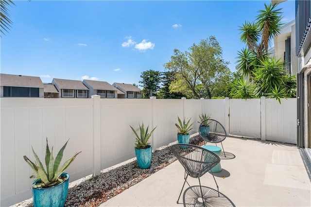 3215 S Lakeview Cir Unit 12104, Hutchinson Island, FL 34949 - view of patio / terrace featuring a fenced backyard and a residential view