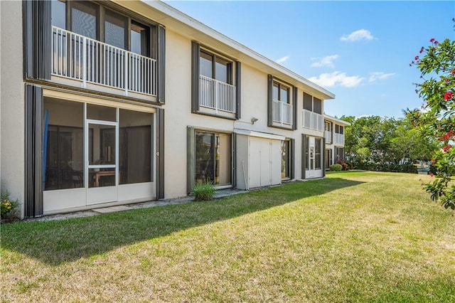 3215 S Lakeview Cir Unit 12104, Hutchinson Island, FL 34949 - back of house with stucco siding and a lawn