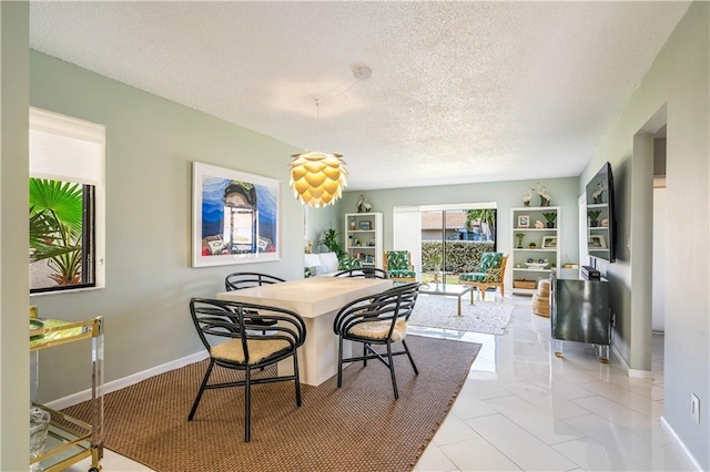 3215 S Lakeview Cir Unit 12104, Hutchinson Island, FL 34949 - dining space with a textured ceiling and baseboards