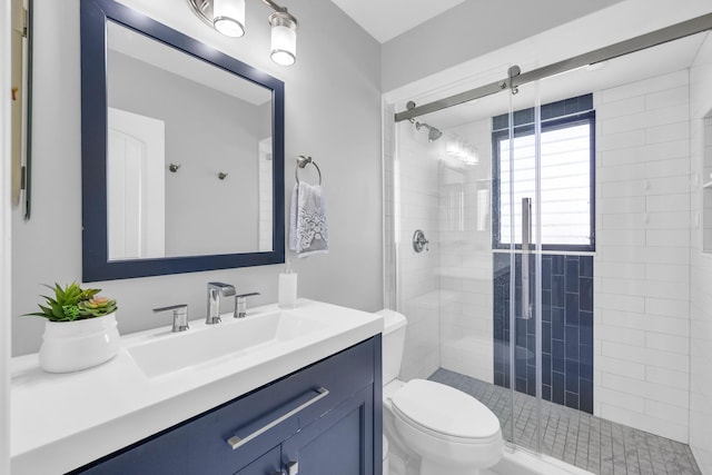 full bathroom with toilet, a shower stall, and vanity