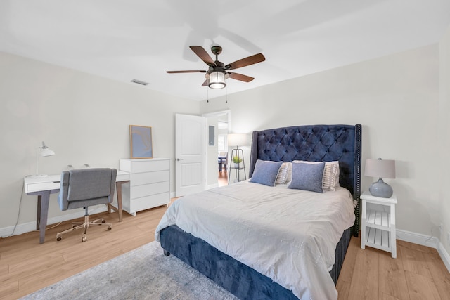 bedroom with wood finished floors, baseboards, and ceiling fan
