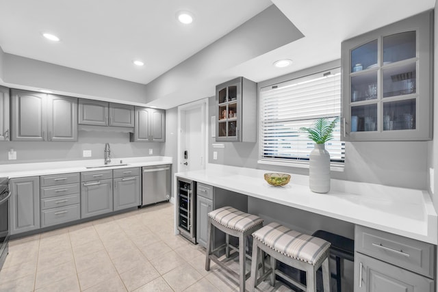 kitchen with gray cabinets, a sink, dishwasher, beverage cooler, and recessed lighting