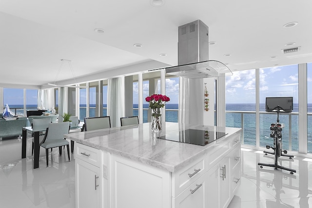 2800 S Ocean Blvd Unit 14A, Boca Raton, FL 33432 - kitchen with light stone counters, visible vents, open floor plan, a center island, and black electric cooktop