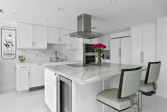 2800 S Ocean Blvd Unit 14A, Boca Raton, FL 33432 - kitchen featuring island exhaust hood, baseboards, wine cooler, and a sink