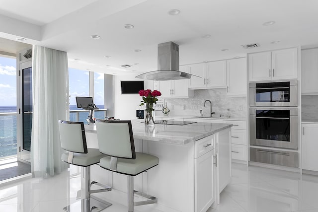 2800 S Ocean Blvd Unit 14A, Boca Raton, FL 33432 - kitchen with a sink, a warming drawer, island range hood, white cabinetry, and backsplash