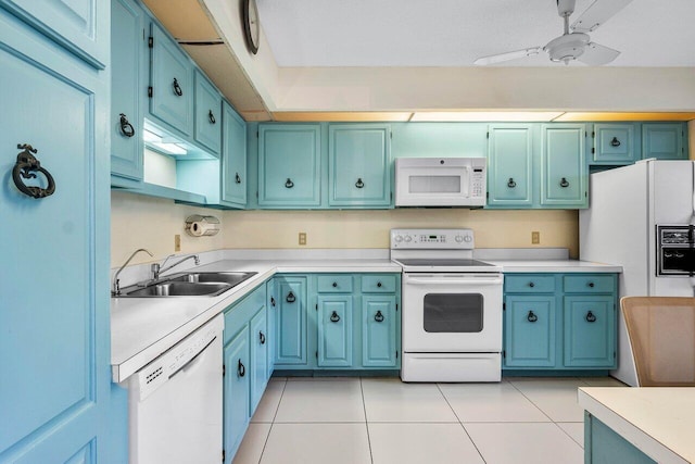 kitchen with white appliances, a sink, light countertops, and light tile patterned floors