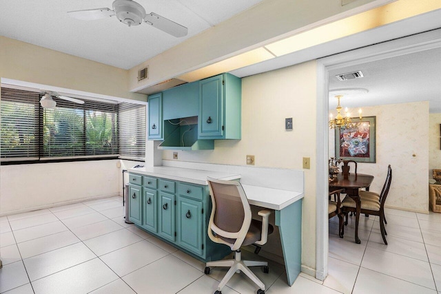 kitchen featuring ceiling fan, light countertops, blue cabinetry, and light tile patterned flooring