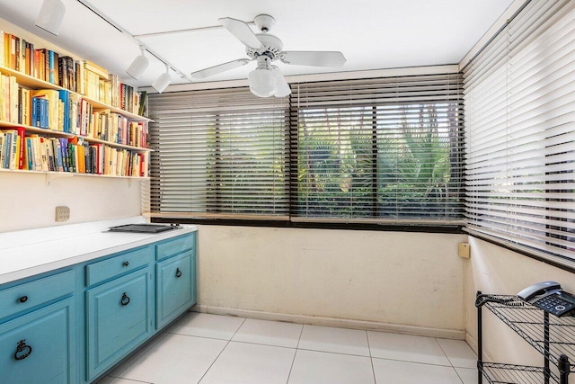 kitchen with blue cabinets, open shelves, healthy amount of natural light, and a ceiling fan