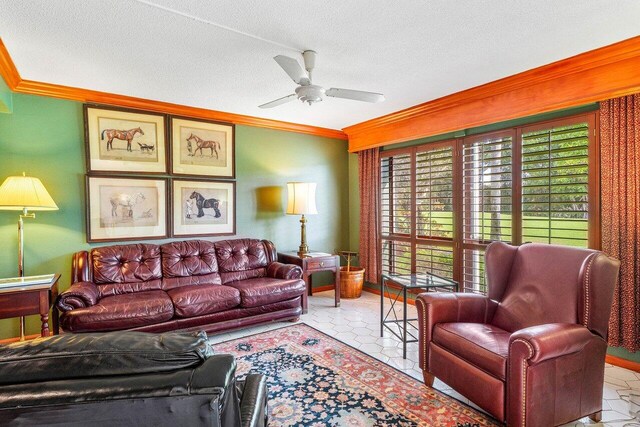 tiled living room featuring crown molding, ceiling fan, a textured ceiling, and baseboards