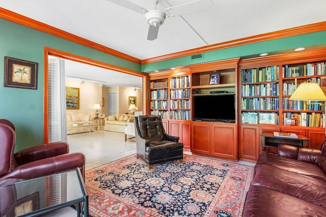 tiled living room featuring ornamental molding, a ceiling fan, a textured ceiling, and built in shelves